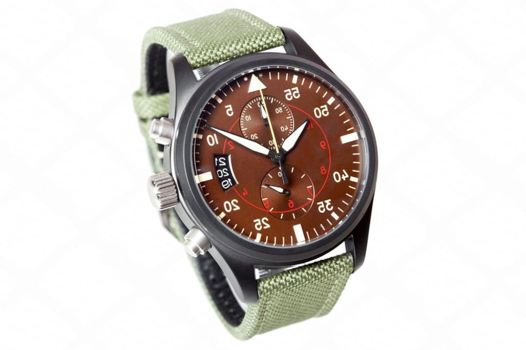 Automatic pilot chronograph watch with a green canvas strap, the kind of piece that needs regular winding to stay healthy