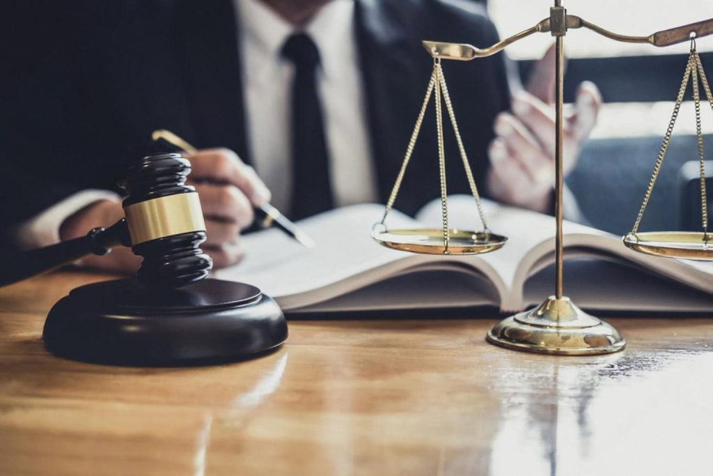 Gavel and scales of justice on a lawyer's desk in a Dubai law firm